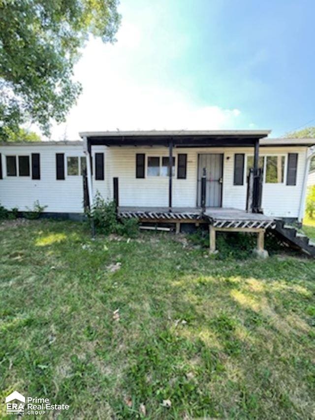 single story home with a porch and a front lawn