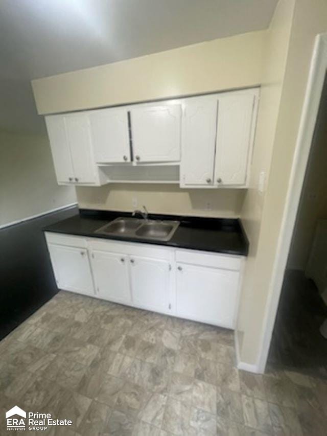 kitchen featuring white cabinetry and sink