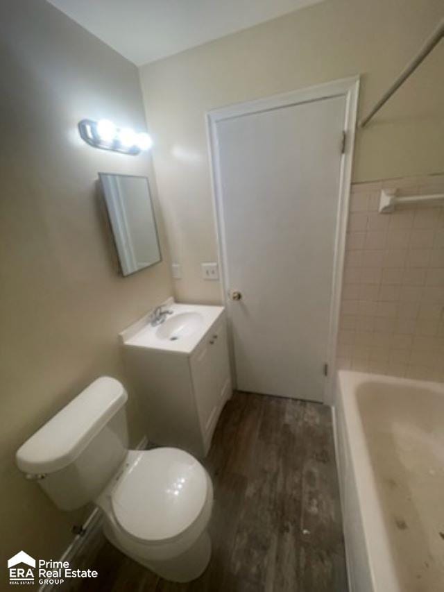 bathroom featuring hardwood / wood-style floors, vanity, and toilet