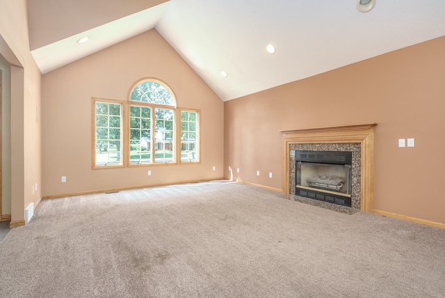 unfurnished living room featuring lofted ceiling, a fireplace, and carpet floors