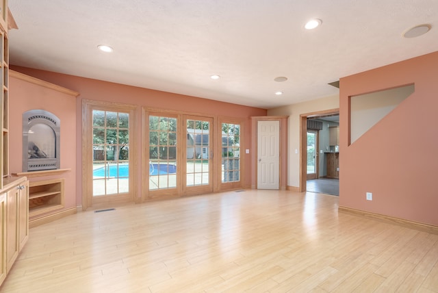 unfurnished living room with light hardwood / wood-style flooring