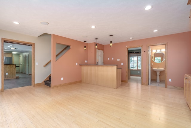 living room featuring wet bar and light wood-type flooring