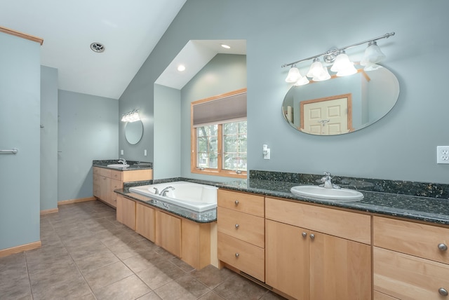 bathroom with lofted ceiling, tile patterned flooring, and vanity