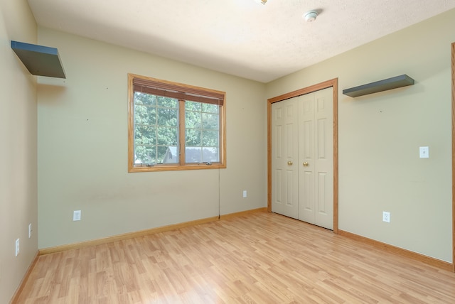 unfurnished bedroom with light hardwood / wood-style floors and a closet