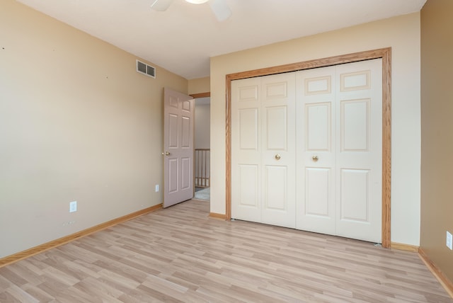 unfurnished bedroom with a closet, ceiling fan, and light wood-type flooring