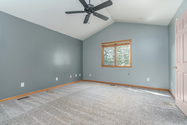 unfurnished room with lofted ceiling, ceiling fan, and carpet flooring