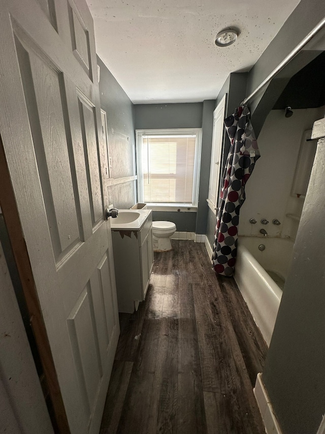 full bathroom featuring hardwood / wood-style floors, vanity, toilet, and shower / bath combination with curtain