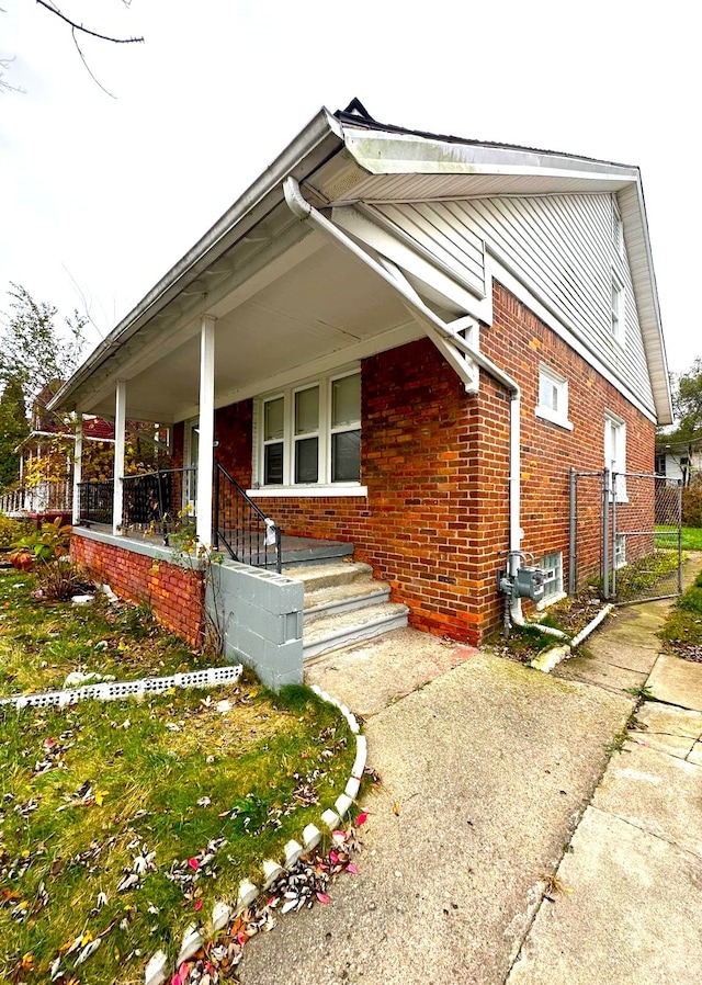 view of property exterior featuring covered porch