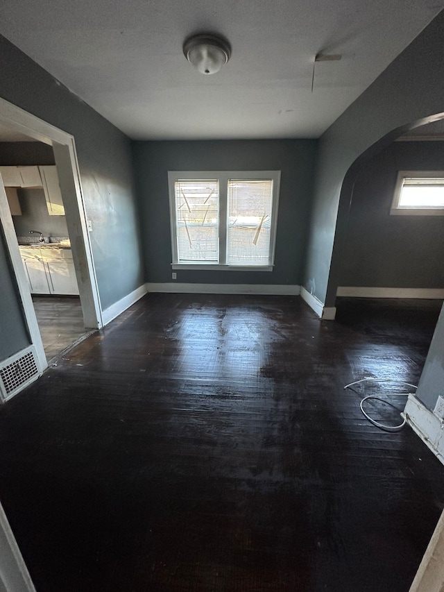 empty room featuring sink and dark hardwood / wood-style floors