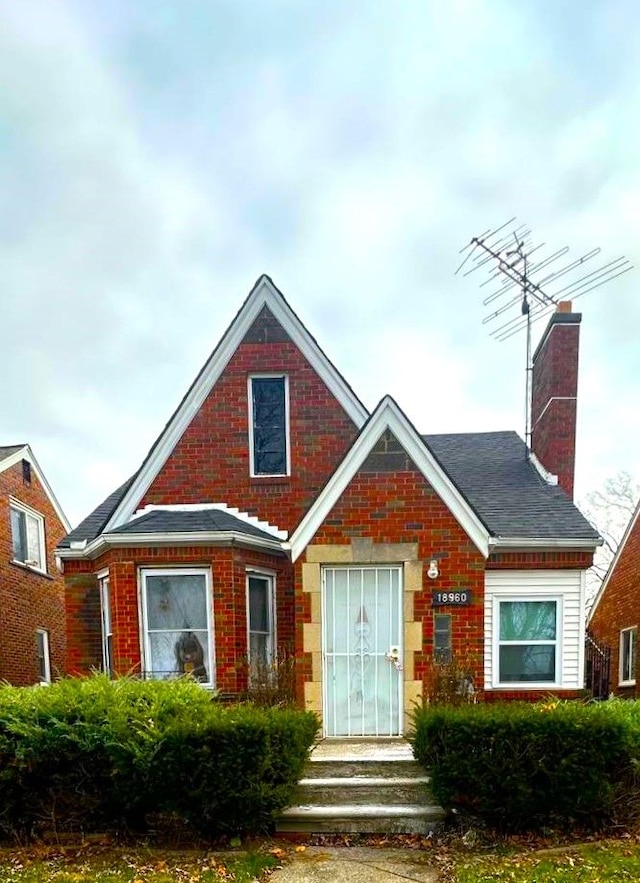18960 Barlow St, Detroit, MI 48205 - view of front of house with a chimney and brick siding