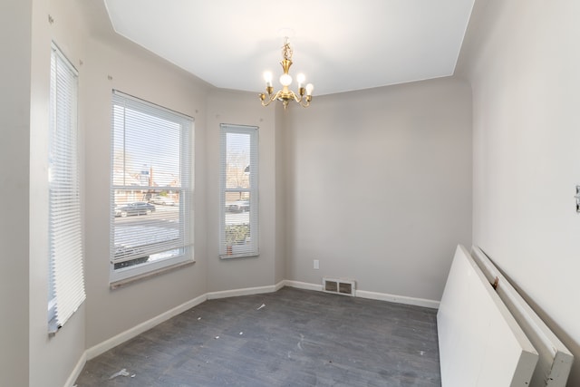 unfurnished room featuring a notable chandelier