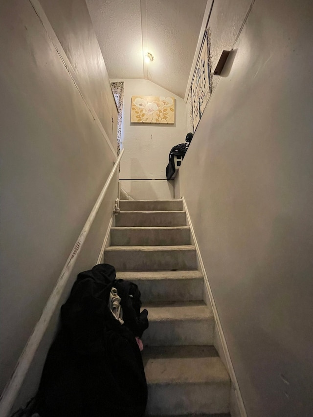 18960 Barlow St, Detroit, MI 48205 - staircase featuring lofted ceiling and a textured ceiling
