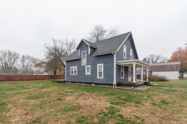 view of home's exterior with covered porch and a lawn