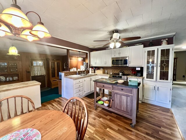 5376 Circle Dr, Reading, MI 49274 - kitchen with appliances with stainless steel finishes, a sink, white cabinetry, wood finished floors, and ceiling fan