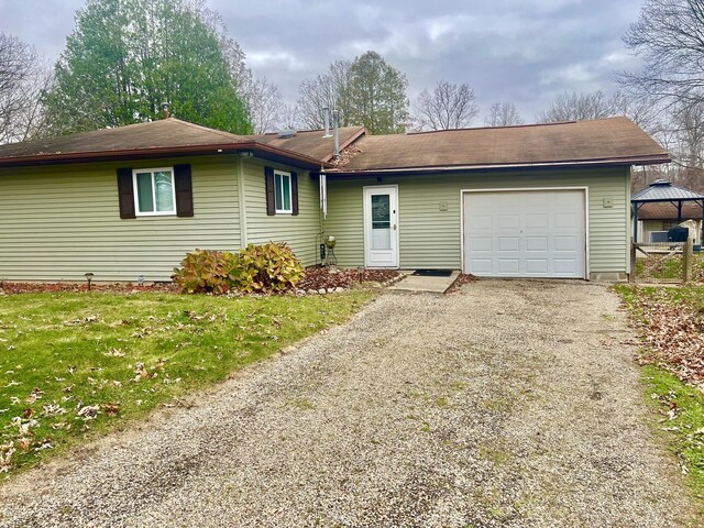 5376 Circle Dr, Reading, MI 49274 - ranch-style home with a gazebo, an attached garage, gravel driveway, and a front lawn
