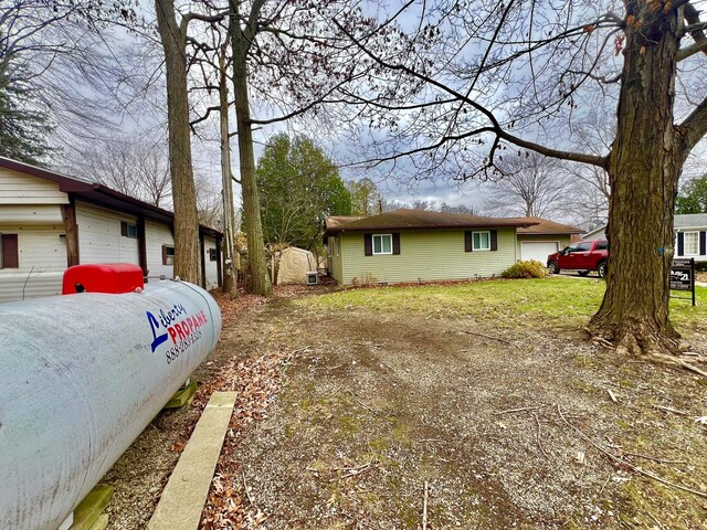 5376 Circle Dr, Reading, MI 49274 - view of side of home featuring a garage and driveway