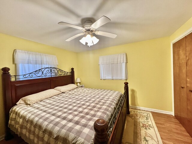 5376 Circle Dr, Reading, MI 49274 - bedroom with wood finished floors, baseboards, and ceiling fan