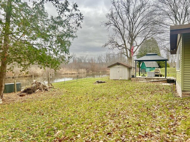 5376 Circle Dr, Reading, MI 49274 - view of grassy yard with a gazebo, a water view, and central AC