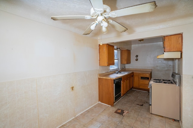 kitchen with ceiling fan, sink, tile walls, dishwasher, and white stove