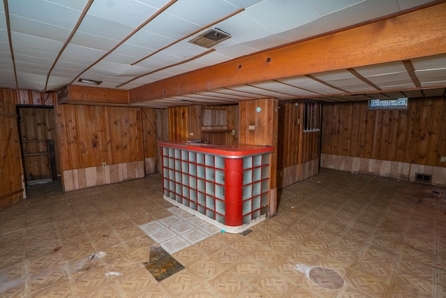 basement featuring wood walls