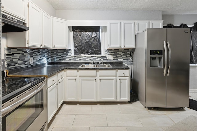 kitchen featuring backsplash, stainless steel appliances, sink, white cabinets, and light tile patterned flooring