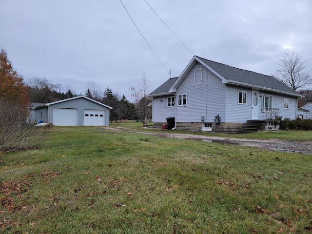 view of property exterior featuring a garage, an outdoor structure, and a yard