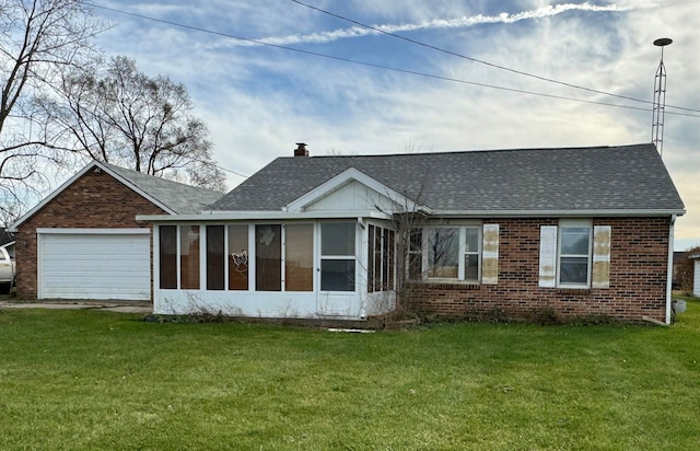 back of house with a sunroom, a garage, and a yard