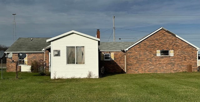 rear view of property with a yard