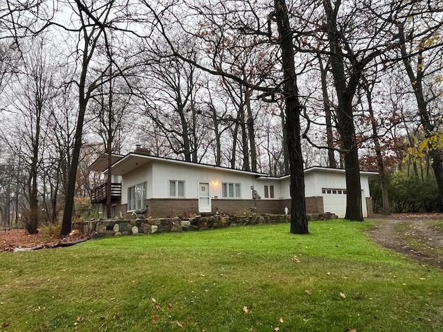 view of front of house with a garage and a front lawn