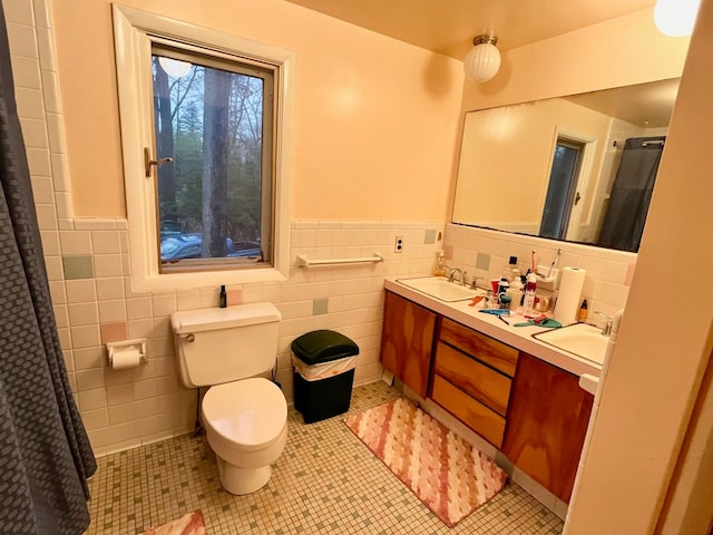 bathroom with tile patterned flooring, toilet, and tile walls