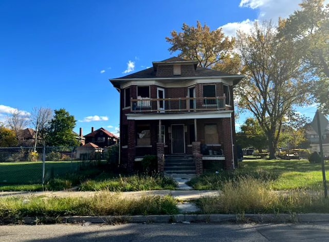 view of front of property featuring covered porch and a balcony