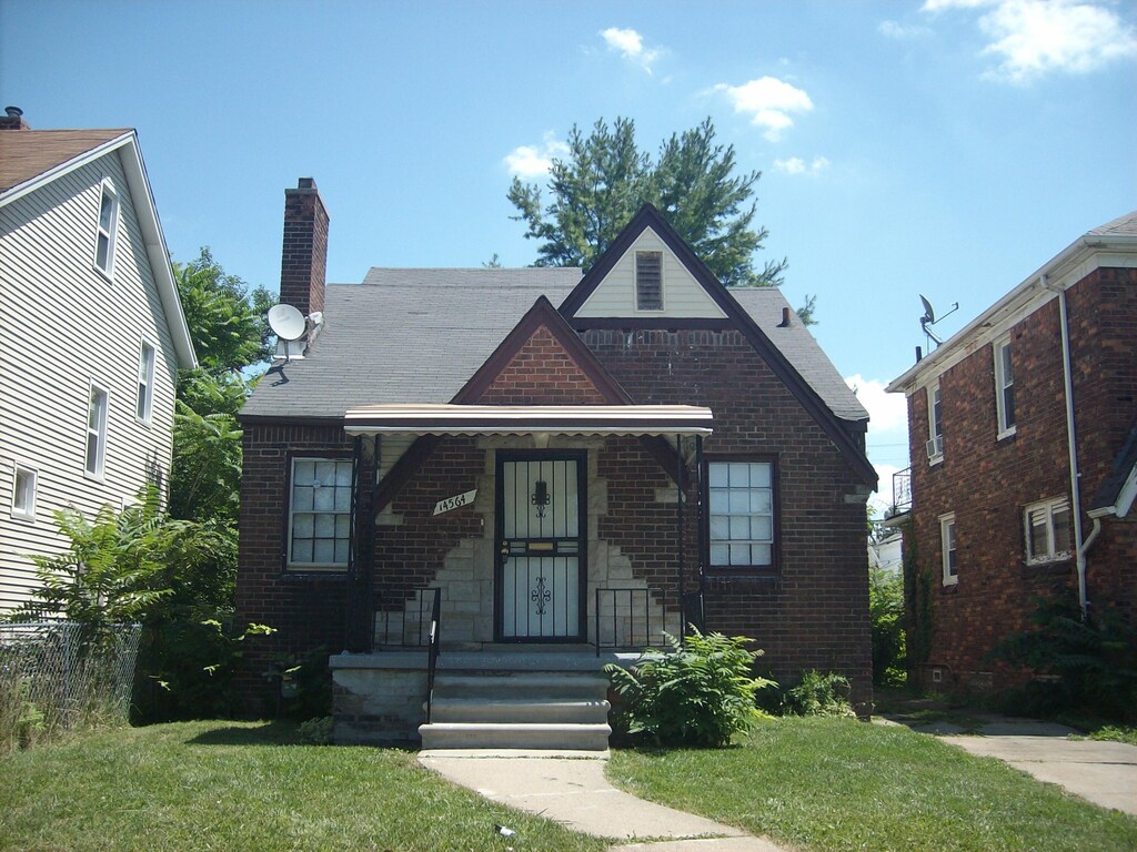 14564 Terry St, Detroit, MI 48227 - tudor home featuring brick siding, a chimney, and a front yard
