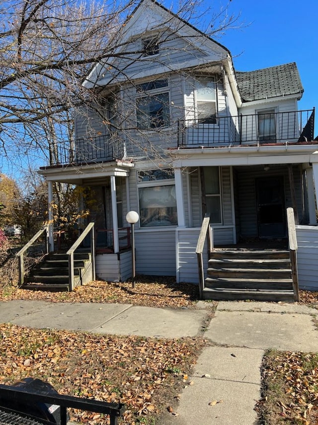 view of front of property with a porch and a balcony