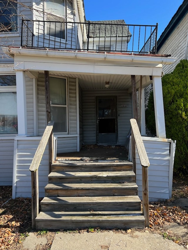 entrance to property with a balcony and covered porch