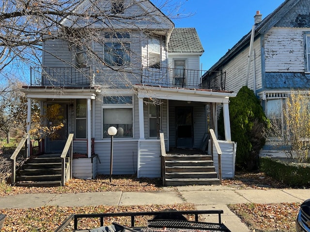 view of front facade featuring a balcony and covered porch