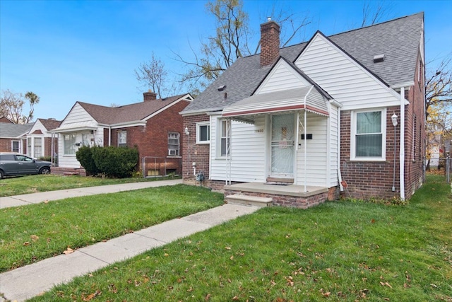 bungalow-style home with a front lawn