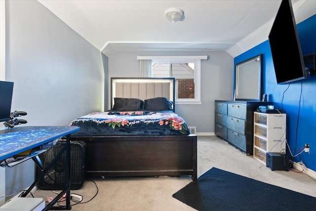 bedroom featuring light carpet and lofted ceiling