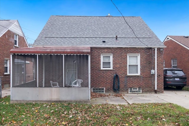 back of house featuring a sunroom