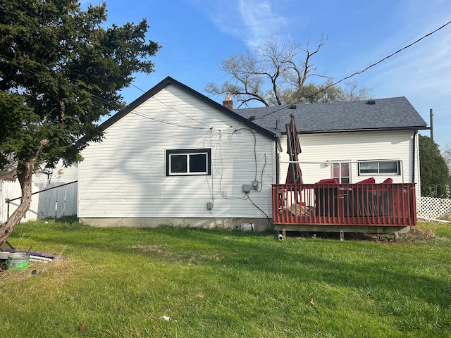 rear view of house with a yard and a deck