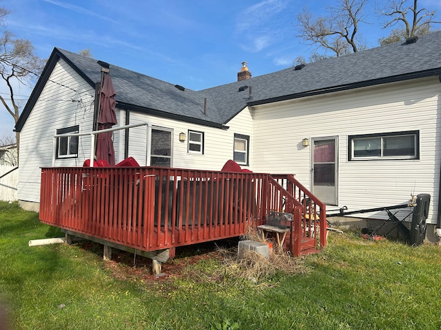 rear view of house featuring a yard and a wooden deck