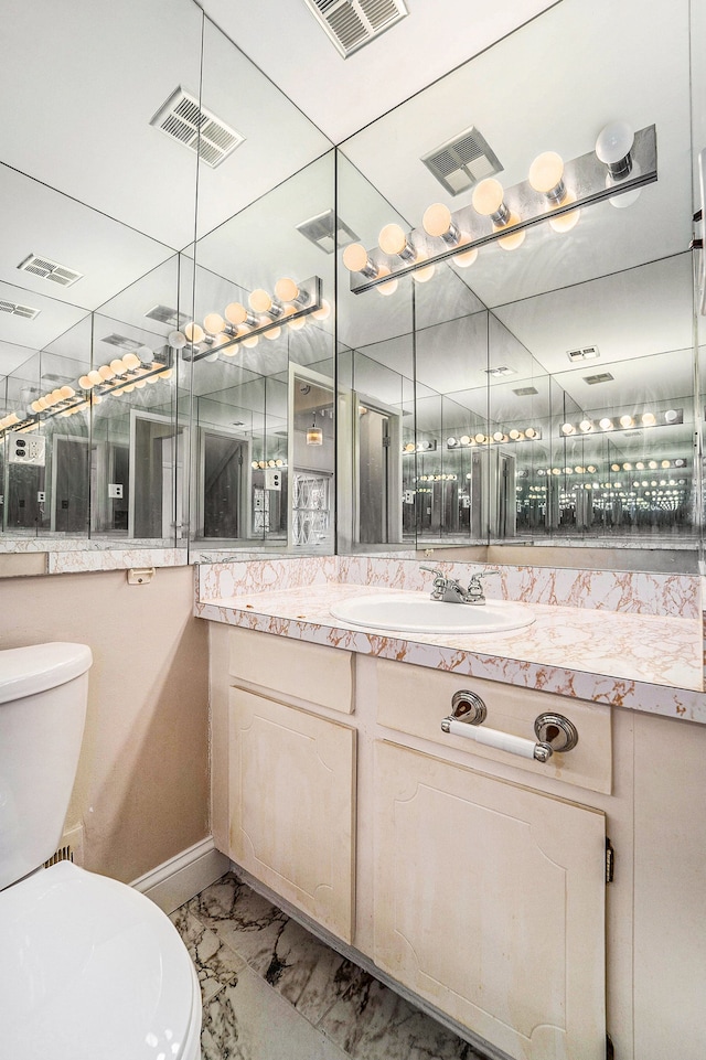 bathroom featuring vanity and toilet