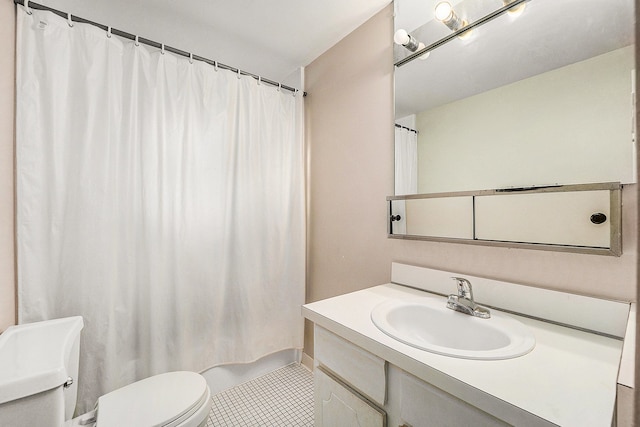 bathroom with tile patterned floors, vanity, a shower with shower curtain, and toilet