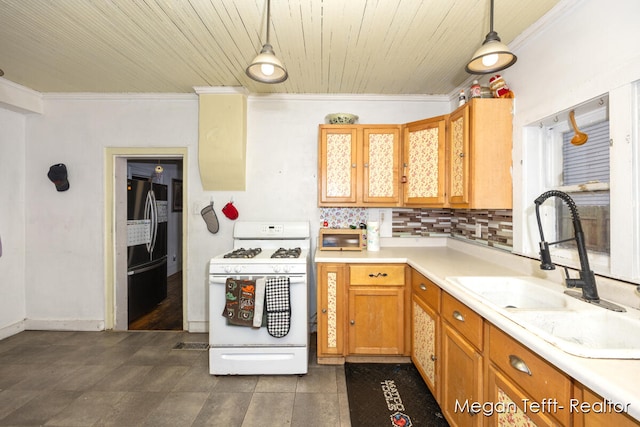 kitchen with pendant lighting, white range with gas stovetop, ornamental molding, and fridge