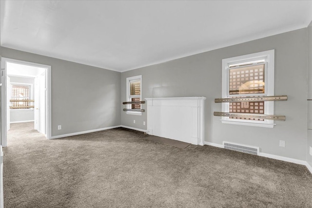 unfurnished living room featuring dark carpet