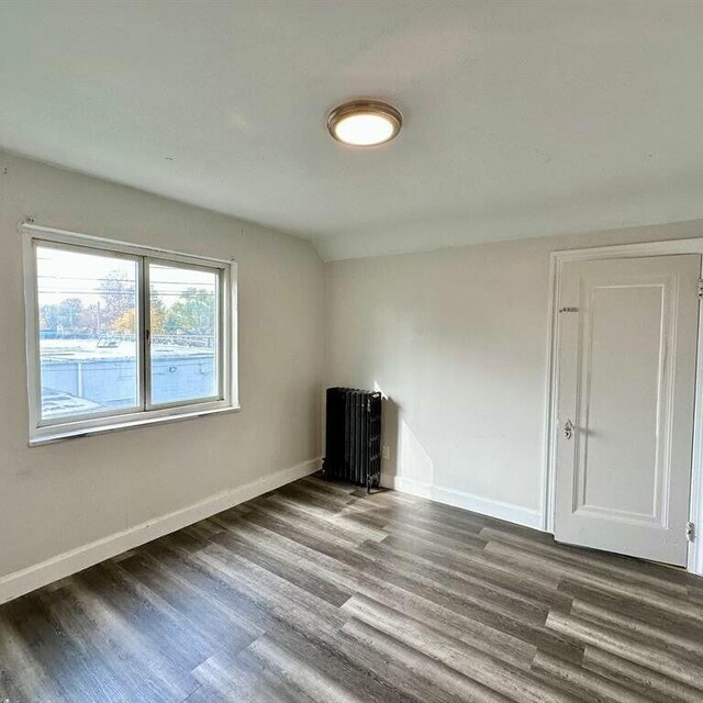 10728 Worden St, Detroit, MI 48224 - empty room with wood finished floors and baseboards