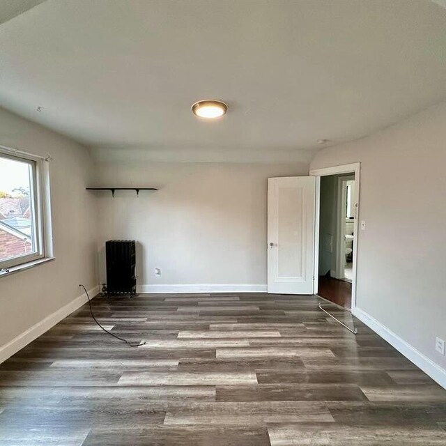 10728 Worden St, Detroit, MI 48224 - unfurnished living room with wood finished floors and baseboards
