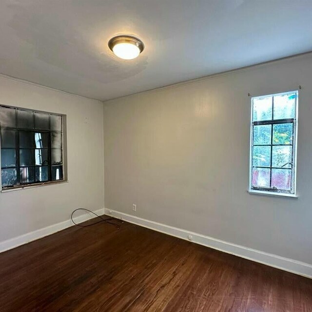 10728 Worden St, Detroit, MI 48224 - empty room featuring baseboards and dark wood finished floors