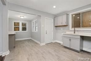 5200 Haverhill St, Detroit, MI 48224 - kitchen with gray cabinets, baseboards, light countertops, and a sink