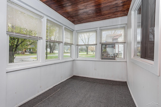 unfurnished sunroom with wooden ceiling