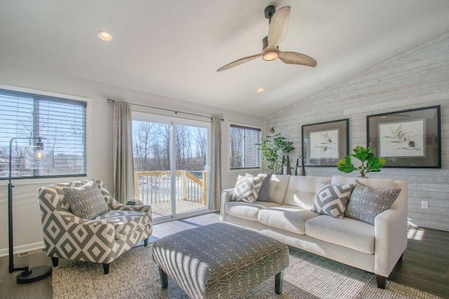 living room with hardwood / wood-style flooring, ceiling fan, and lofted ceiling